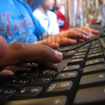 children typing on keyboard