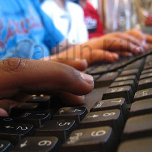 close up image of child's fingers on keyboard