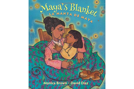 Book cover of Maya's Blanket la Manta de Maya with an illustration of  a grandma holding a granddaughter in a rocking chair wrapped up with a blanket and a dog in their lap.