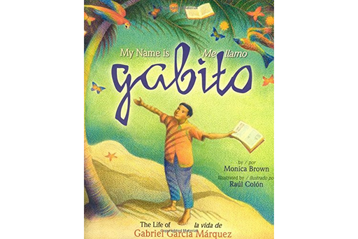 Book cover of Me Llamo Gabito la Vida de Gabriel Garcia Marquez with an illustration of a boy standing on a beach with his arms spread open wide while holding a book in one hand.