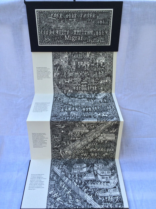 Photograph of inside of book shows text and illustrations of an ancient civilization and its people. Photograph is also showing how the book opens up accordion style, not a typical right to left style.