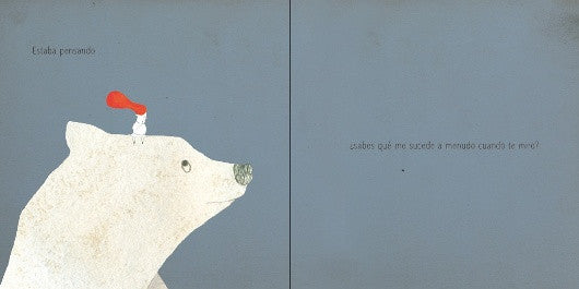inside page of the book depicting an illustration of a little boy standing over a huge polar bear's head.