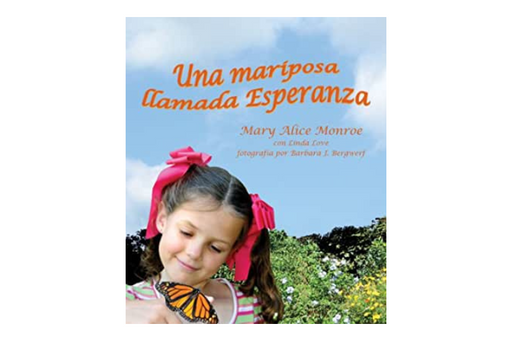 Book cover of Una Mariposa Llamada Esperanza with a photograph of a girl looking at a butterfly.